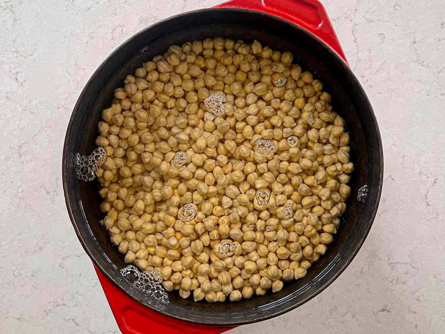 Overhead view of chickpeas in water
