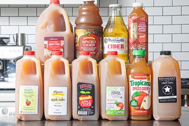 Assortment of apple cider bottles arranged on a counter