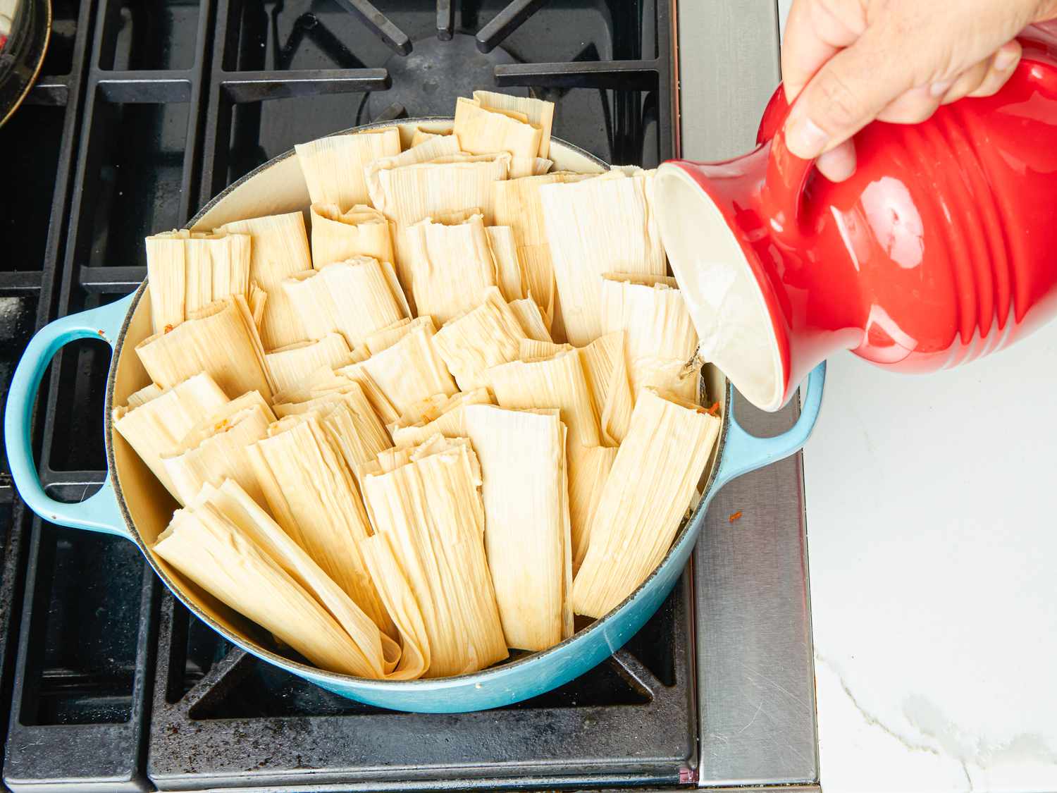 Overhead view of adding water to tamales