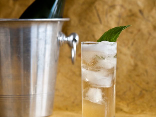 The Devereaux cocktail served over ice in a tall glass garnished with a mint leaf