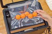 A bag of ping pong balls is vacuum sealed in the Anova Precision Chamber Vacuum Sealer