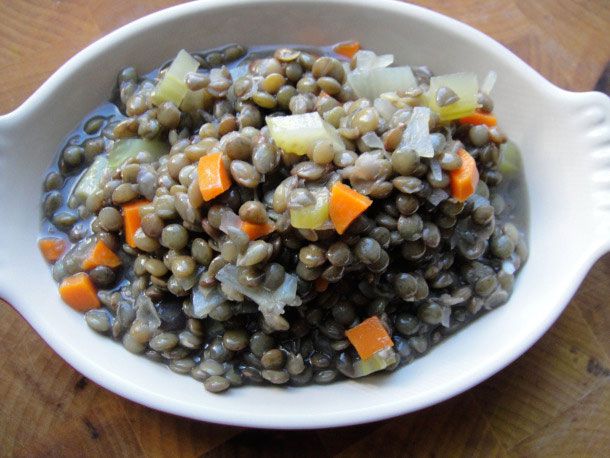 A small dish of cooked basic French green lentils. 