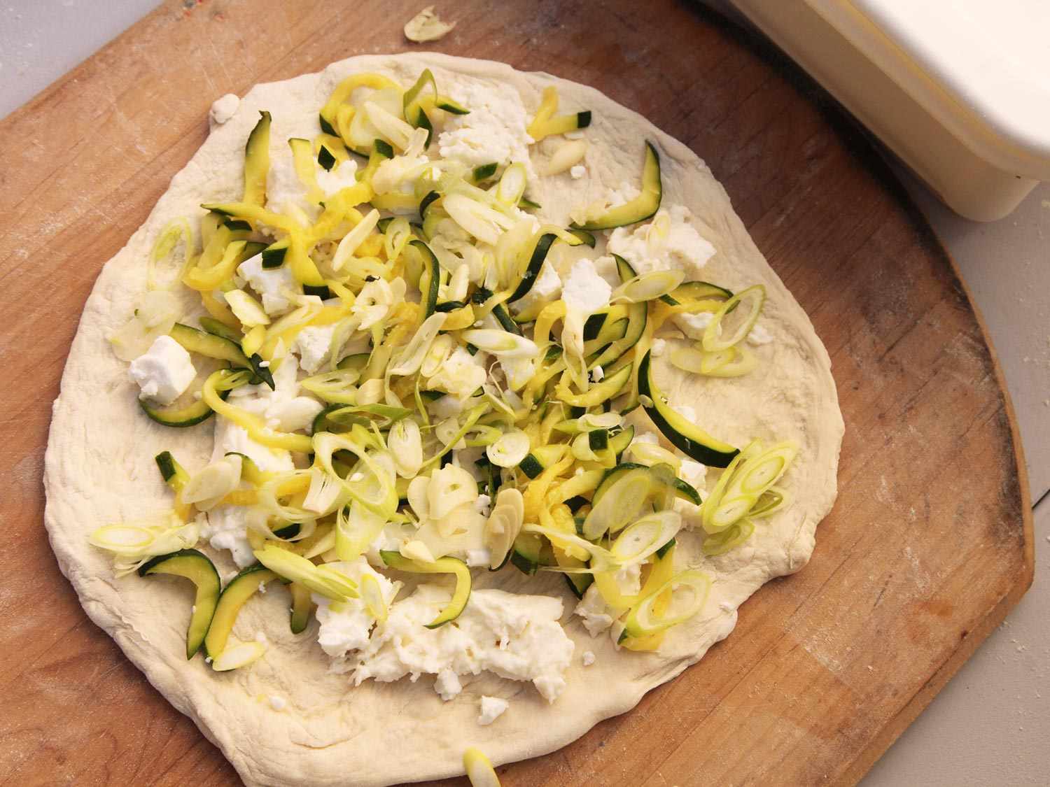 An assembled zucchini pizza, ready to be baked.