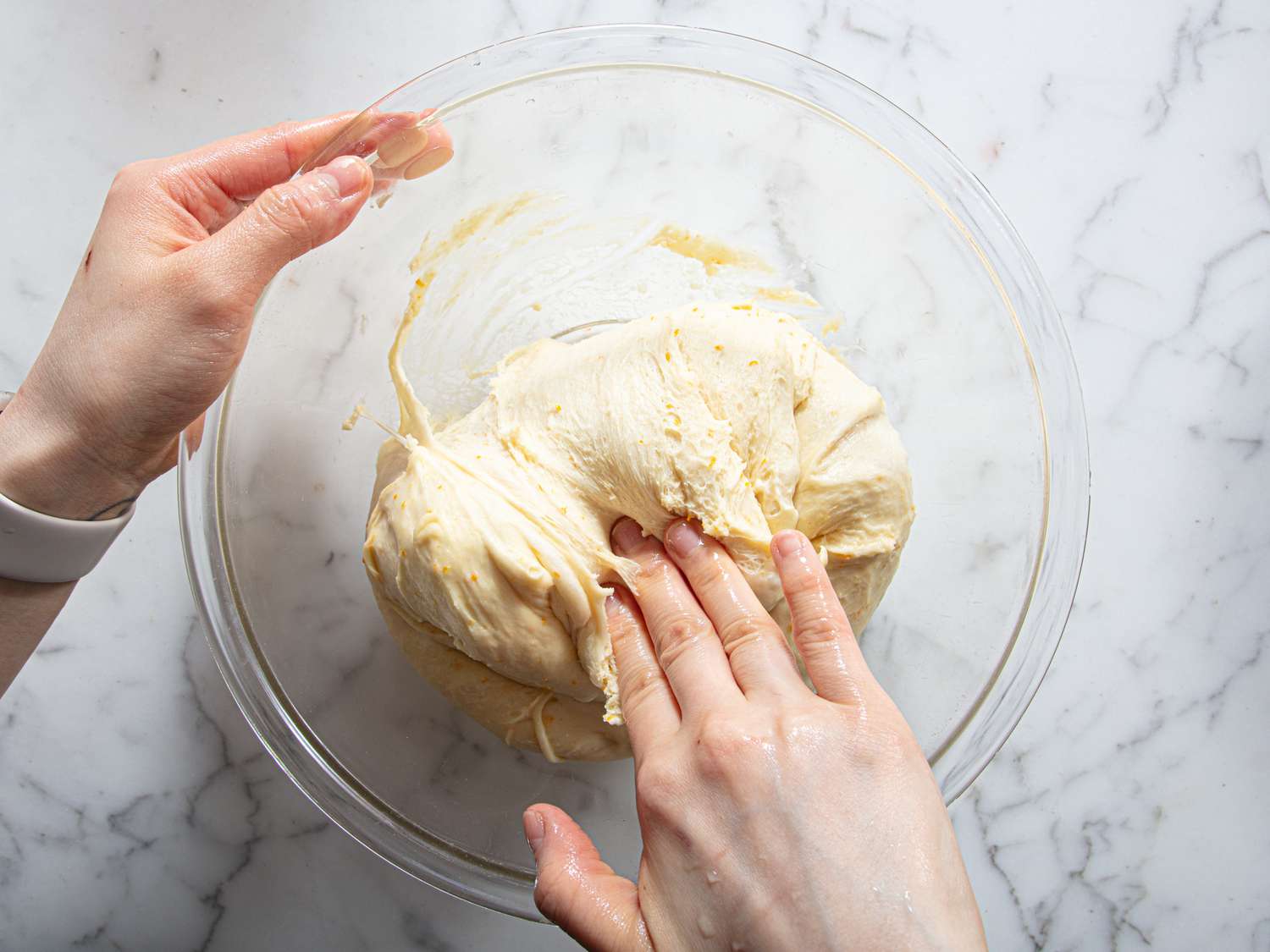 Overhead view of deflating dough
