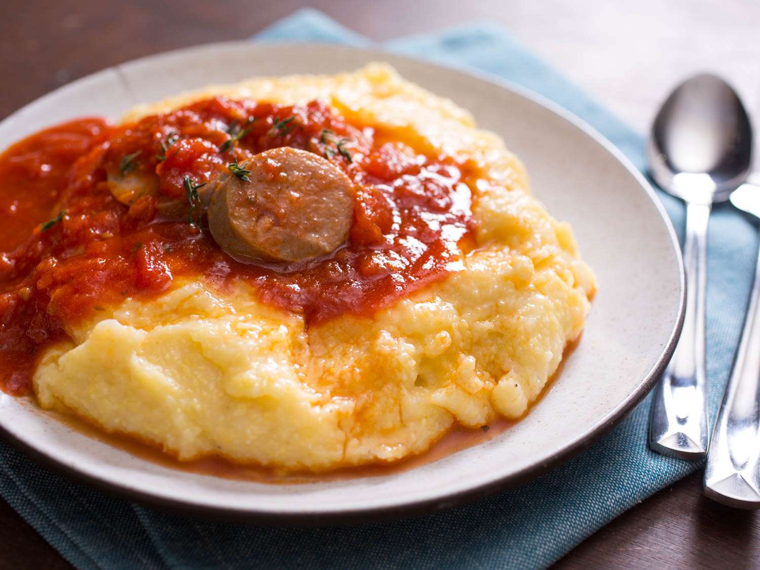 Smooth and creamy polenta topped with tomato sauce and sausage.