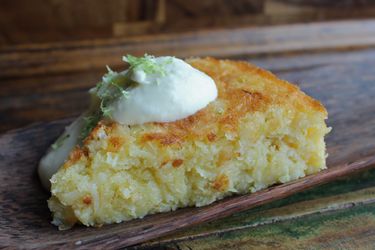 Flourless Bitter Lime Coconut Macaroon Cake, served on a wooden board.