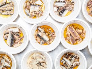 Multiple bowls containing tinned sardines shown in various presentations