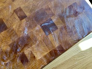 Boos Block Board Cream slathered on a wooden cutting board