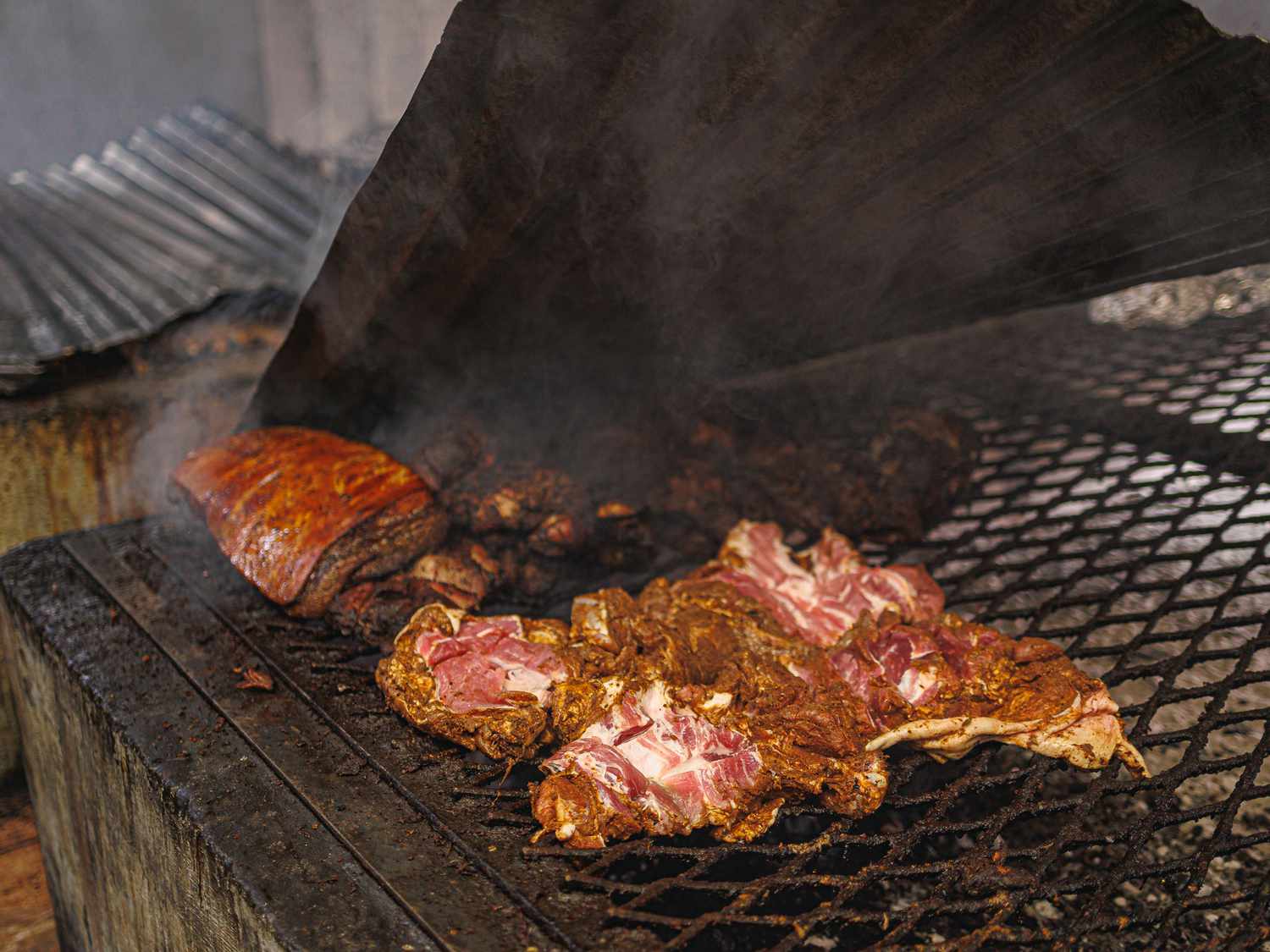 Pork cooking on a grill at Peppa Thyme.