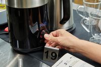 hand turning the dial on the OXO Brew 9-Cup Coffee Maker