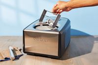 Hand removing the paddle from Cuisinart ICE-100 Compressor Ice Cream and Gelato Maker