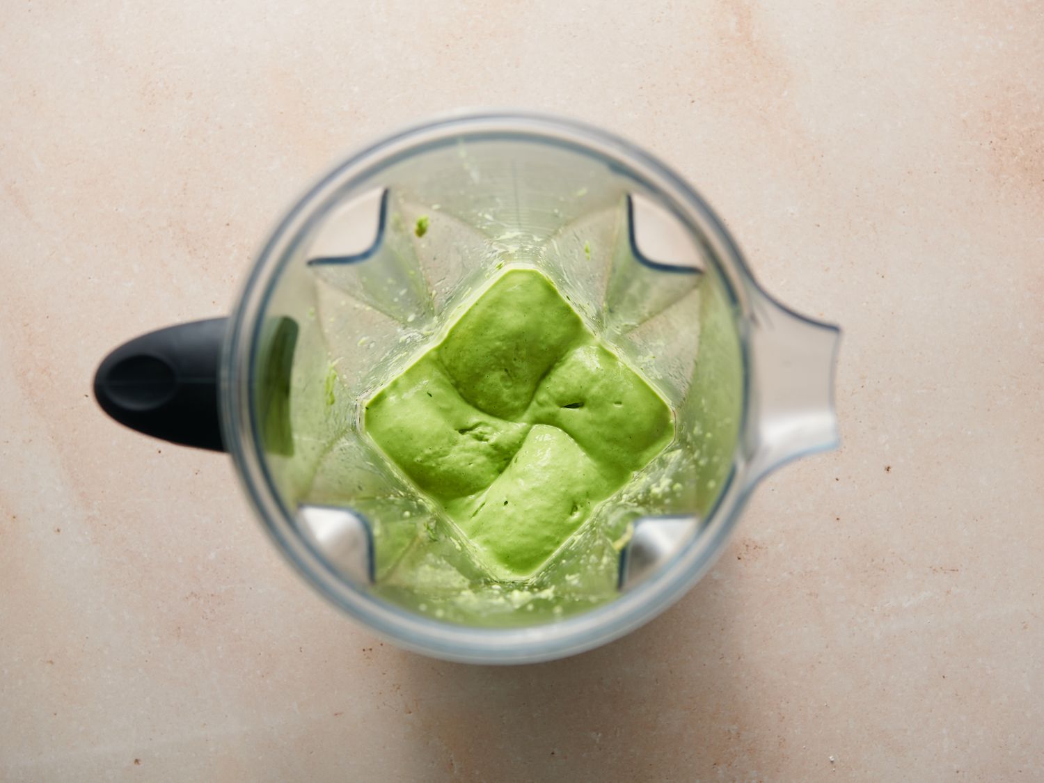 Avocado, jalapeÃ±o, cilantro, vegetable oil, water, and lime juice purÃ©ed into a creamy sauce inside blender seasoned with salt