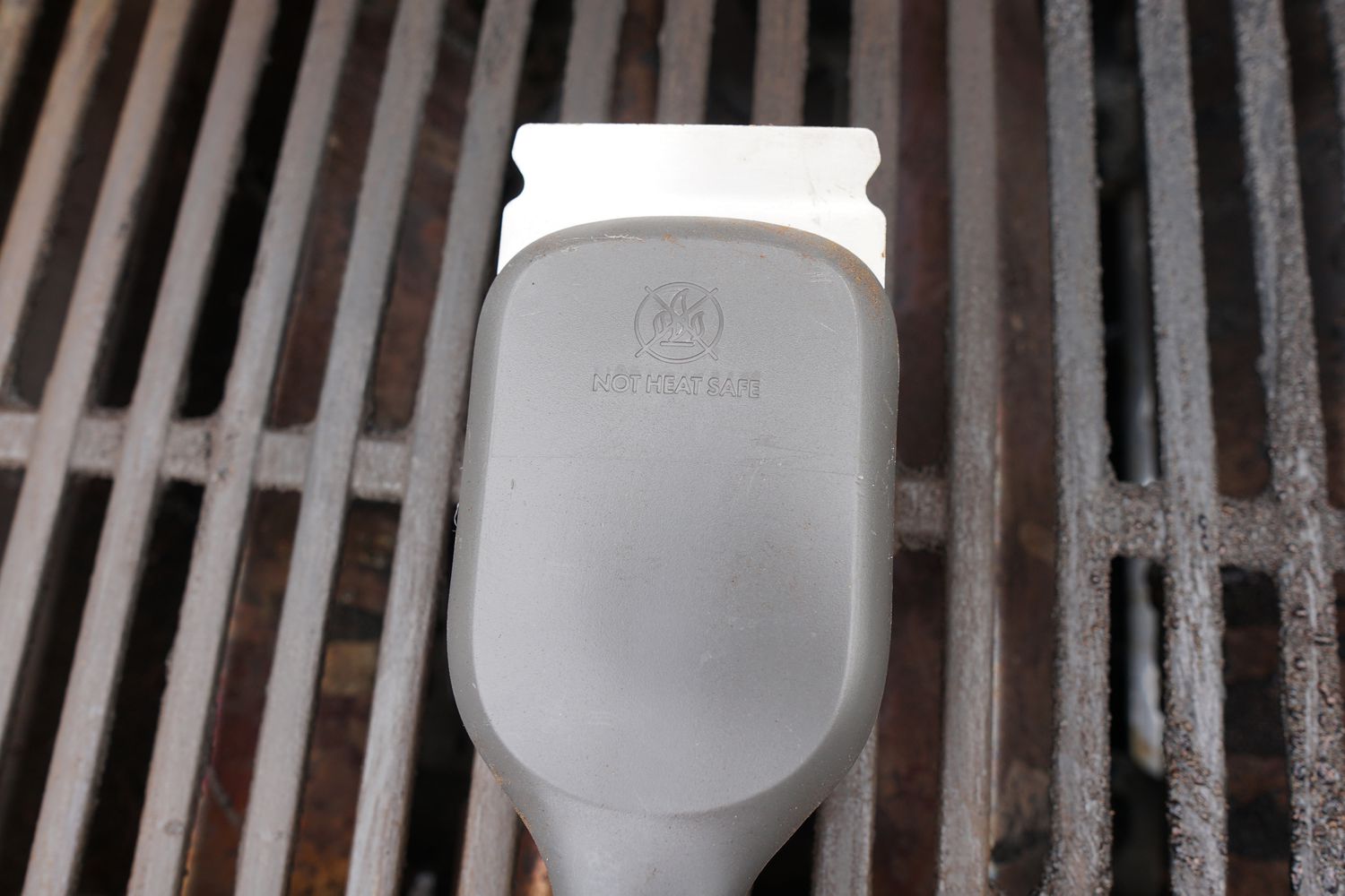 A closeup look at the scraper of a grill brush