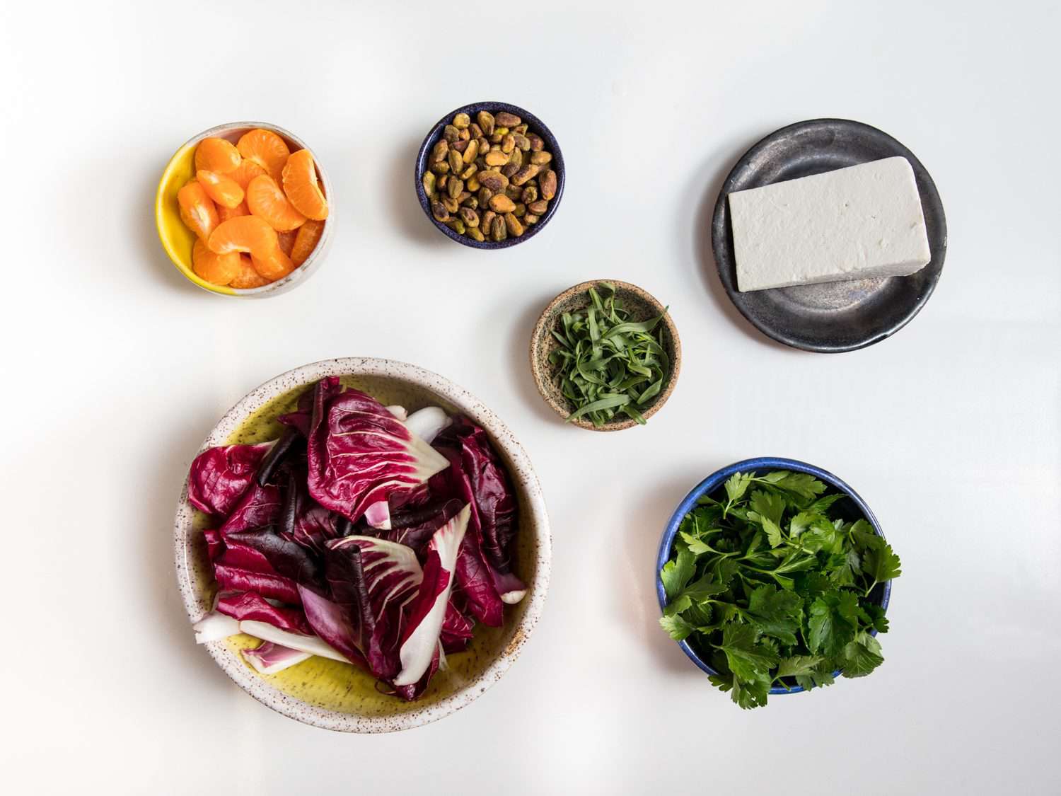 Overhead view of prep bowls containing the ingredients for radicchio salad.