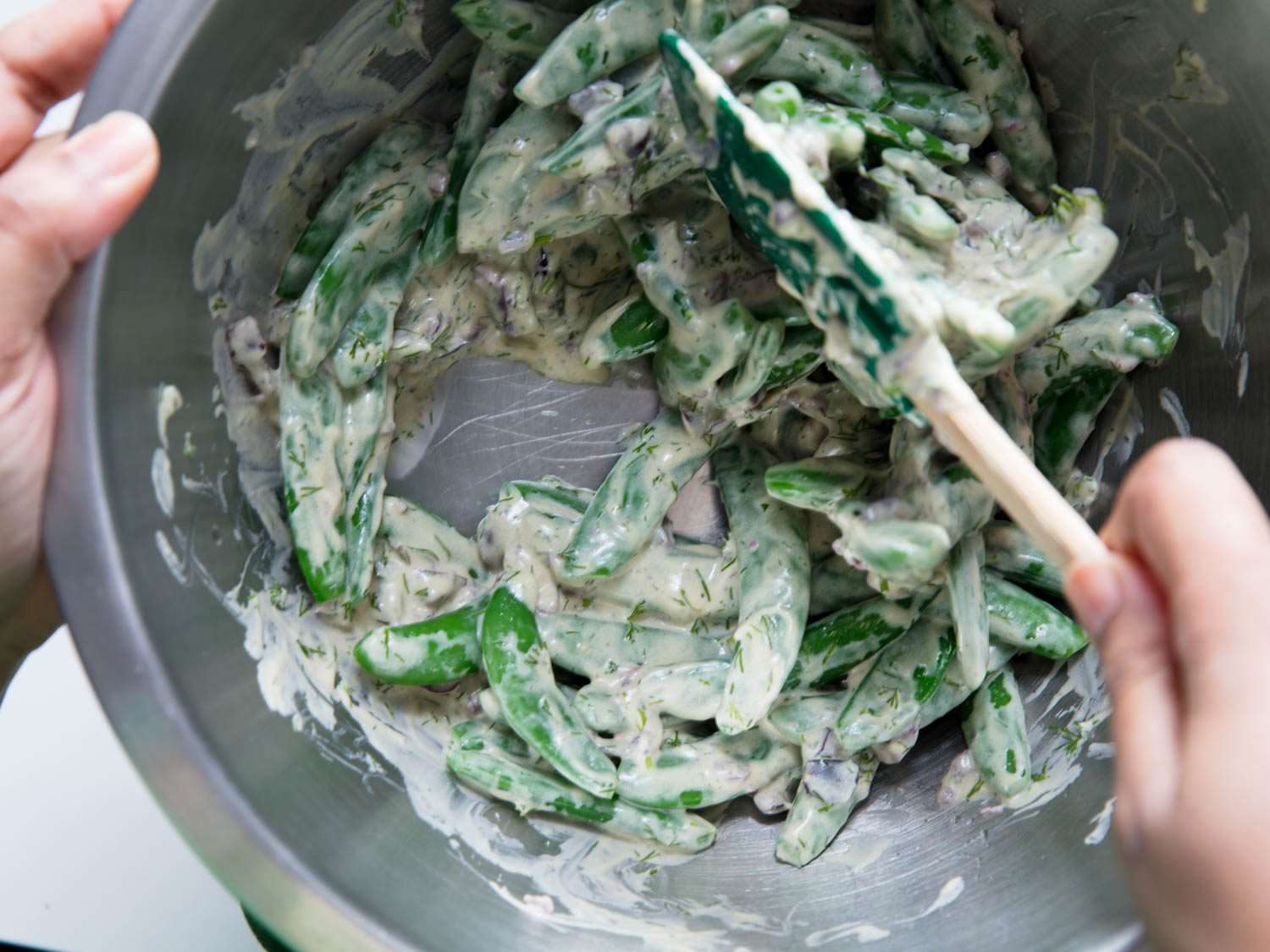 Combining blanched sugar snap peas with garlic yogurt dressing
