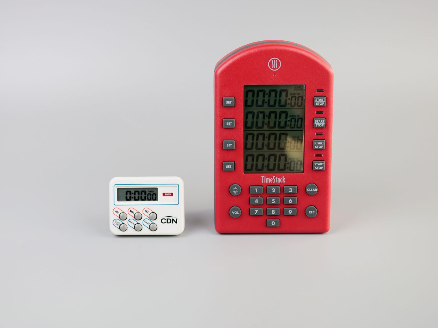 a timer with a full keypad next to a timer without one