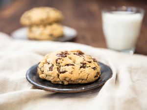 Levain Bakery-style super thick chocolate chip cookie with milk.