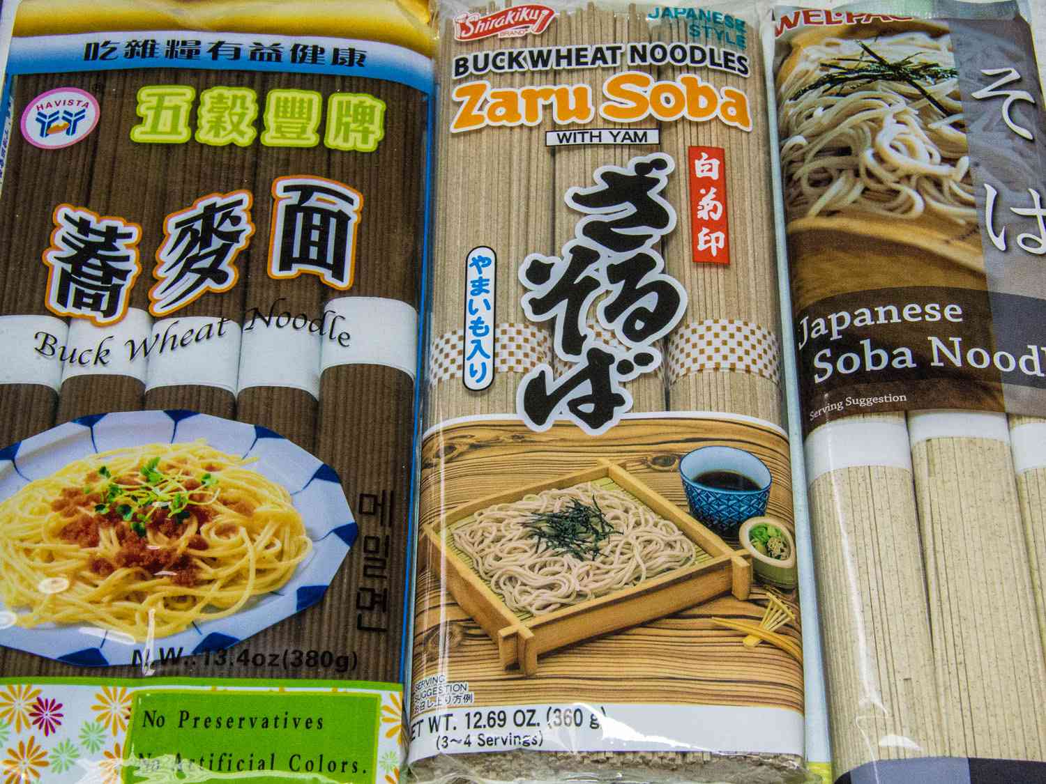Three different packages of soba noodles.