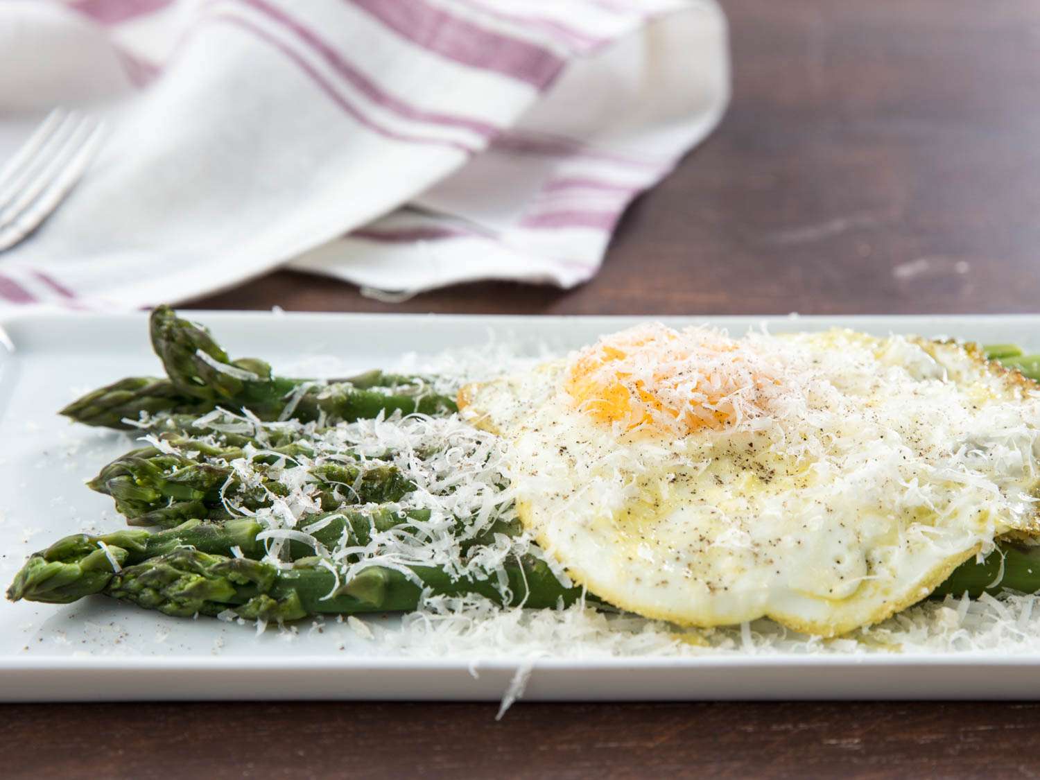 Closeup of Asparagus alla Milanese (Poached Asparagus With Fried Egg and Parmesan Cheese)
