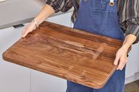 Person holding a Virginia Boys Kitchens Walnut Wood Cutting Board