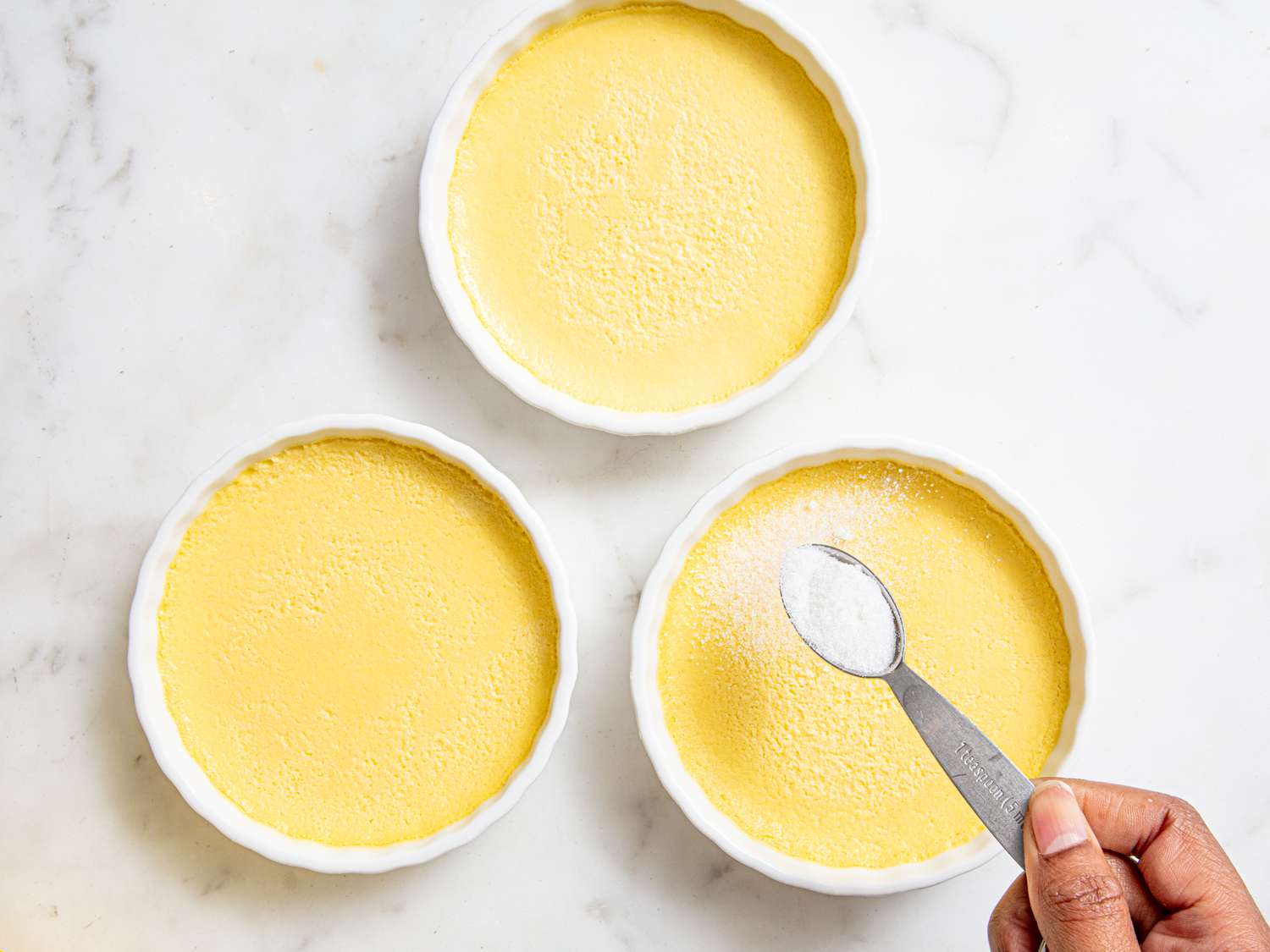 Overhead view of adding sugar