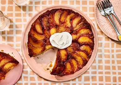 Overhead view of finished peach upside down cake with a slice removed