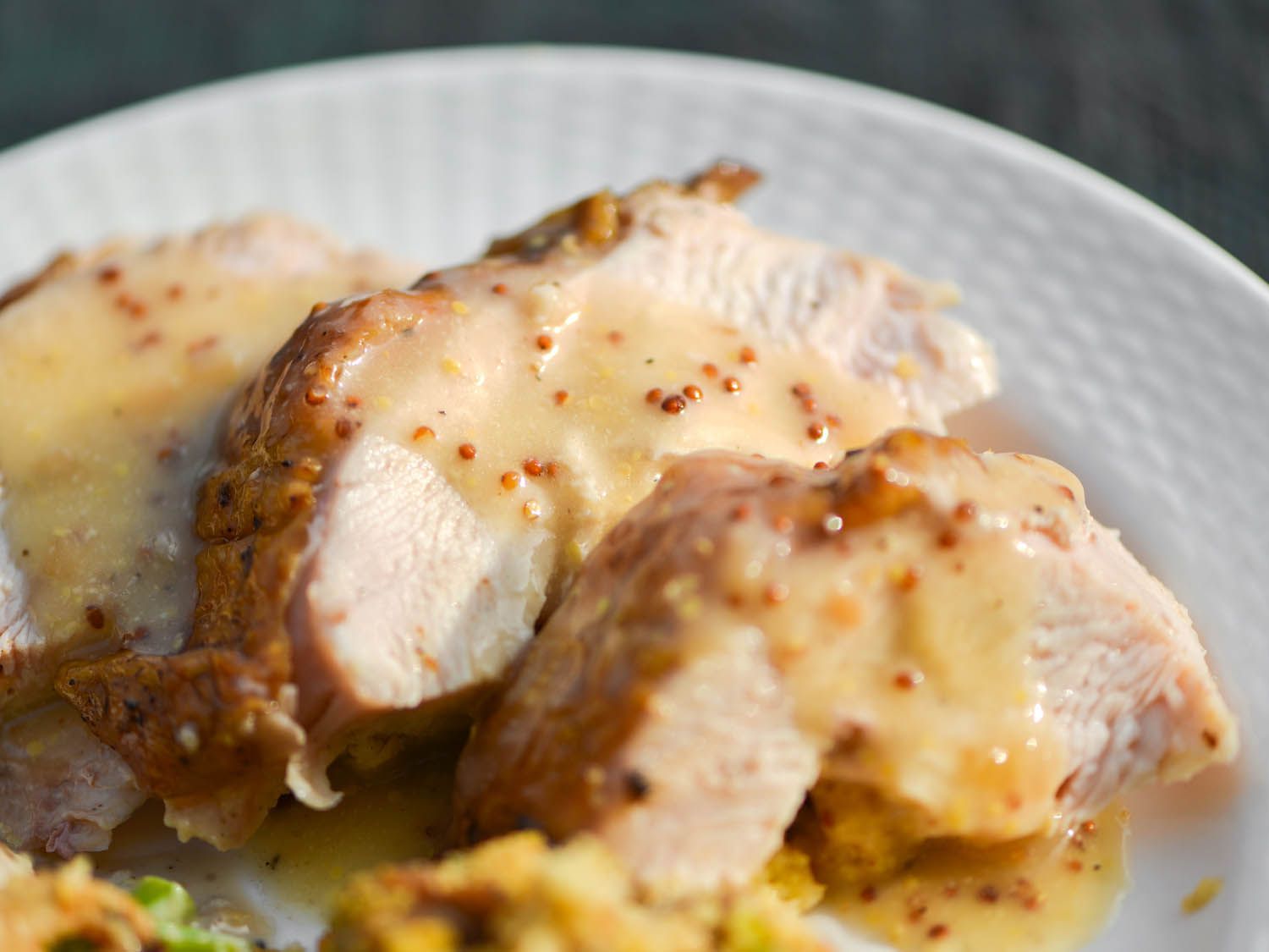 Sliced grilled turkey with gravy.