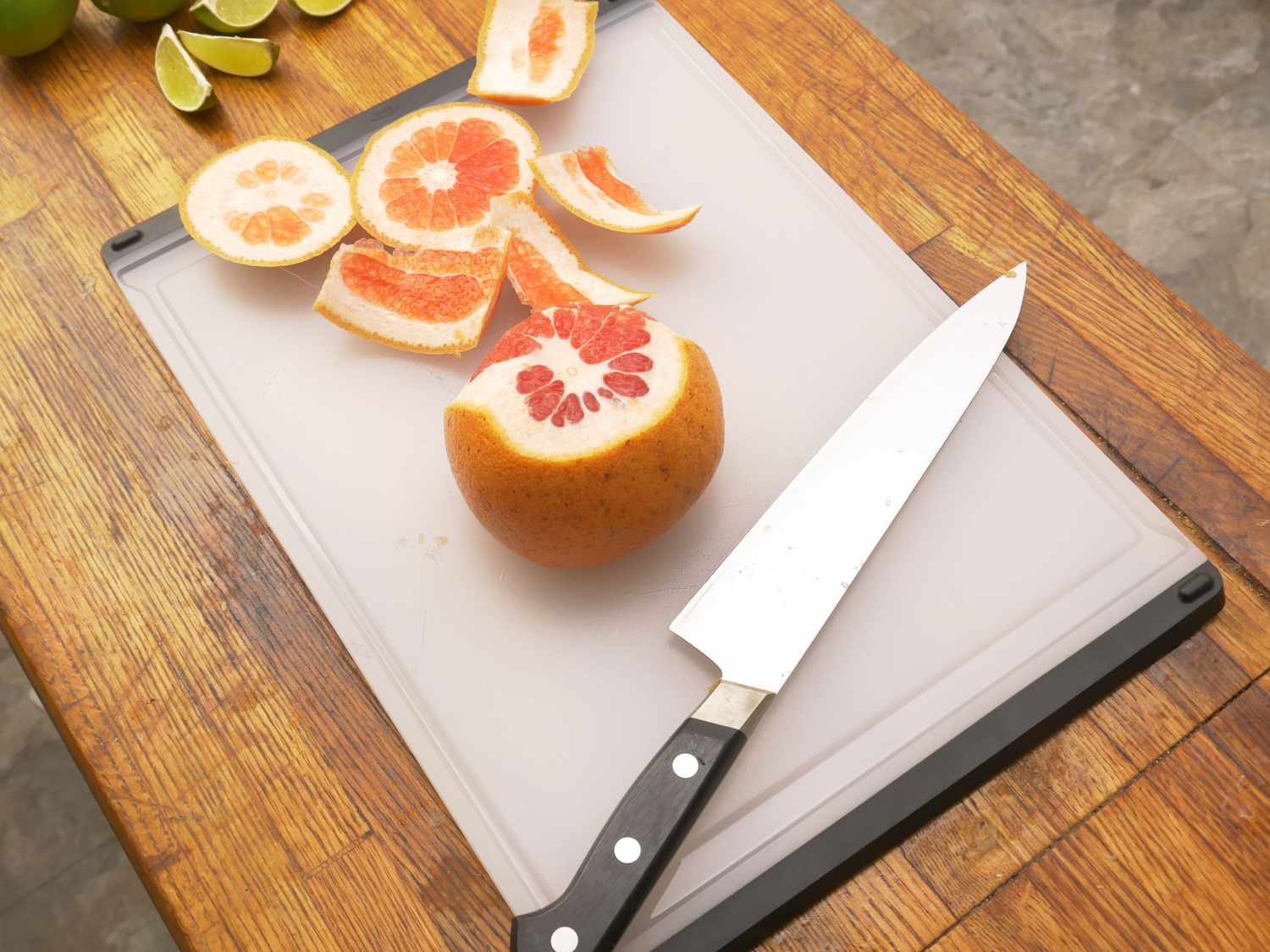 the oxo plastic cutting board with a grapefruit on it