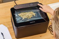 A bag of cereal is vacuum sealed using the Anova Precision Chamber Vacuum Sealer