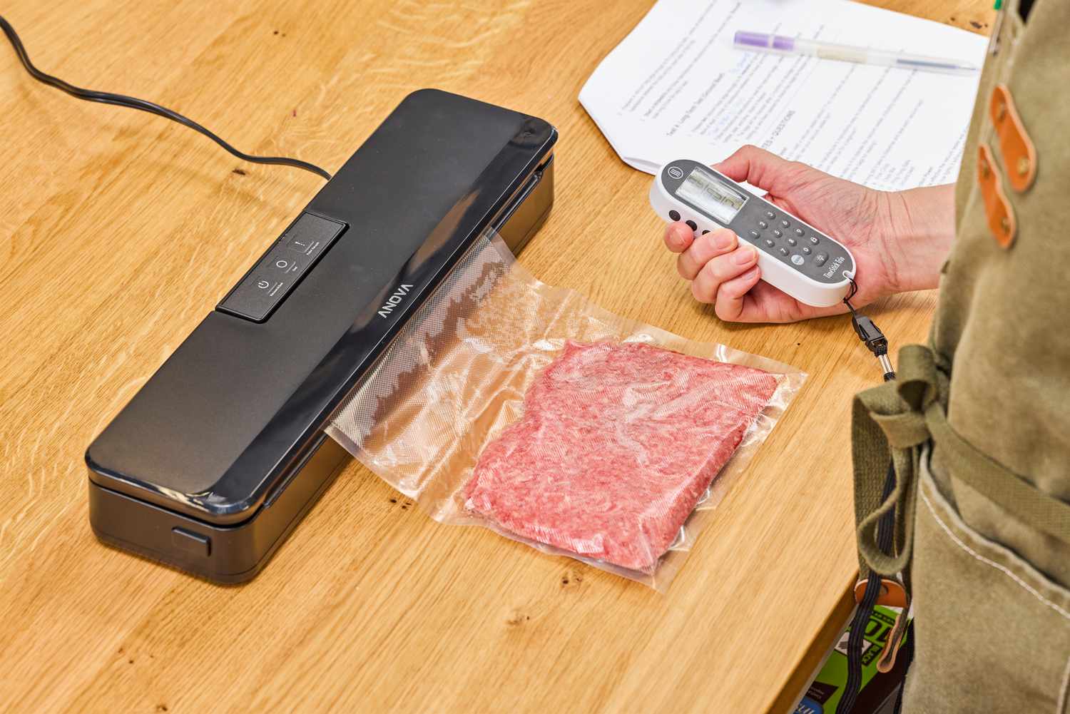 A bag of meat being vacuum sealed using Anova Precision Sous Vide Vacuum Sealer