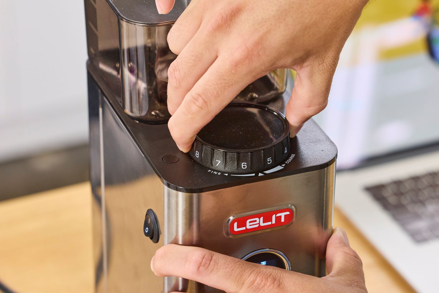 A person adjusts the grind settings on the Lelit William Espresso Grinder