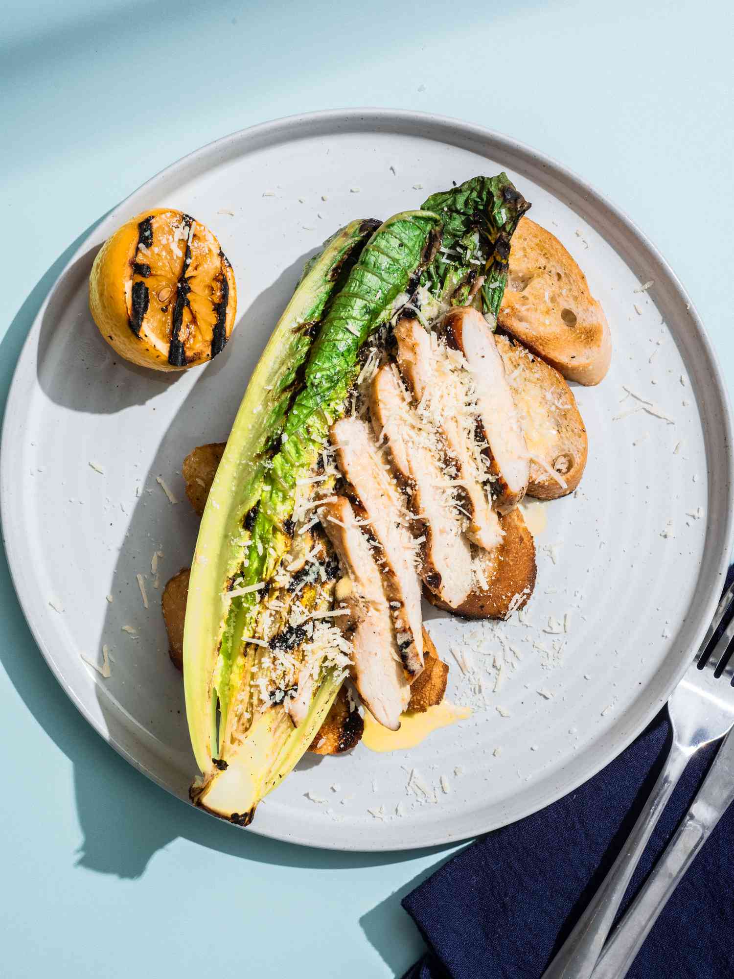 Grilled chicken caesar on a plate.