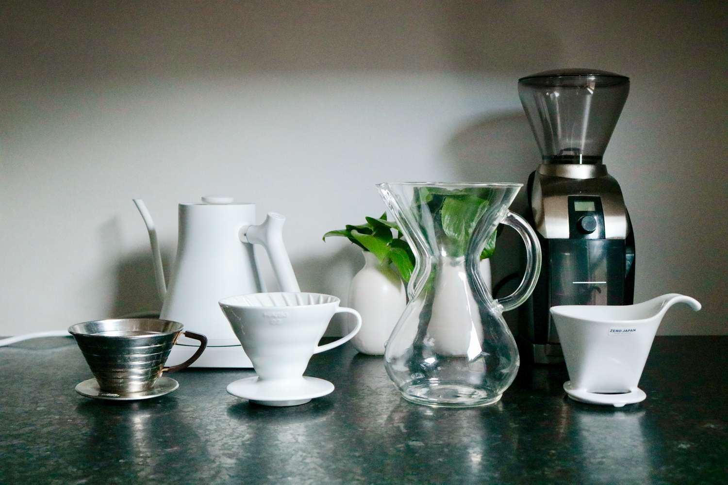 Four different styles of pourover makers on a table