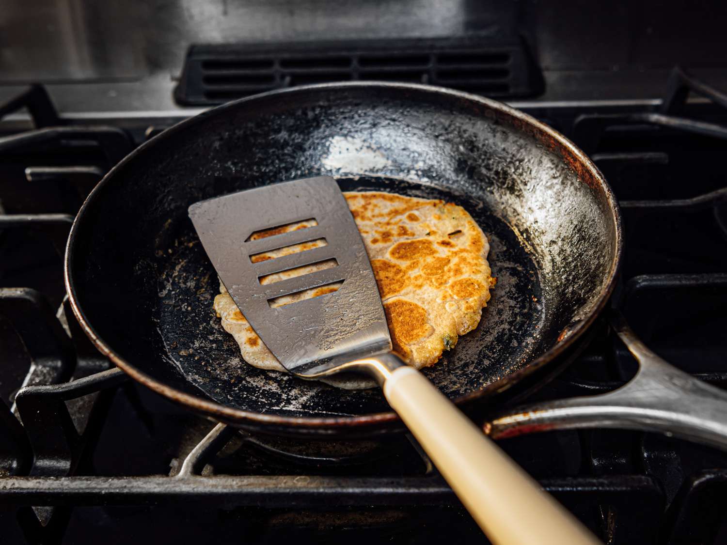 A paratha is cooked in a skillet.