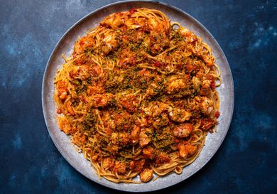 The pasta on a large serving platter, sprinkled with parsley-flecked breadcrumbs.