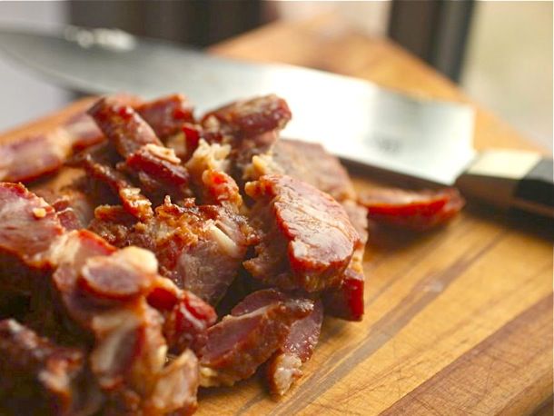Closeup of sliced char sui pork, ready to be julienned and added to the egg roll filling.
