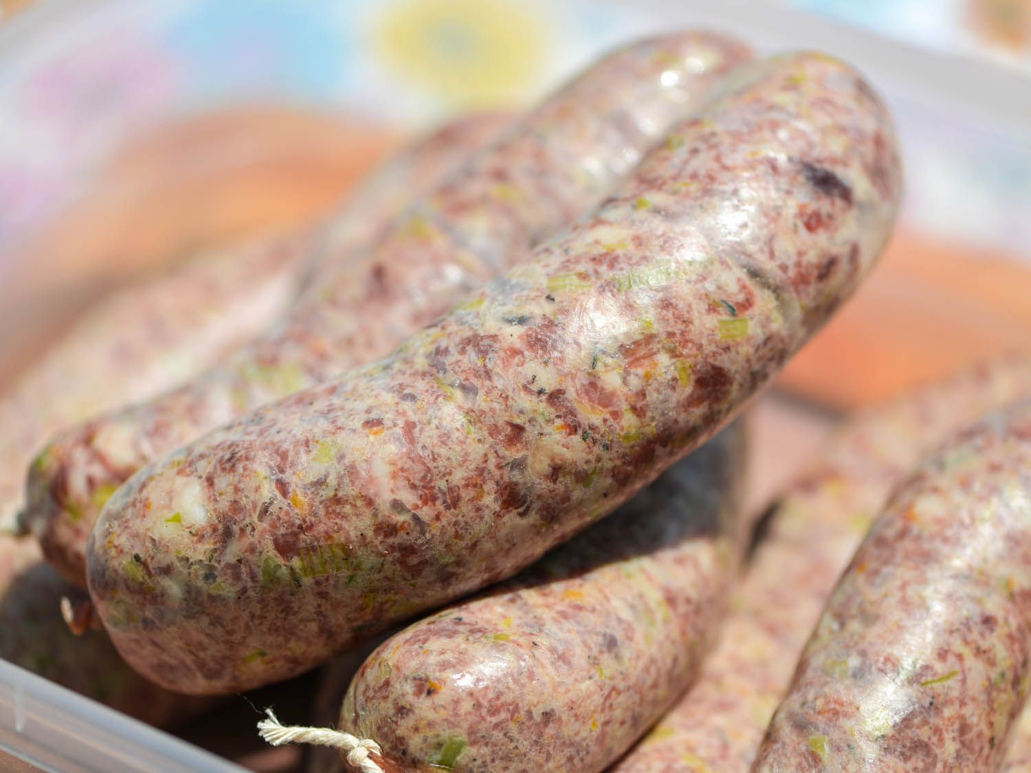 Close-up of lightly cured loukaniko sausages, ready to be grilled.