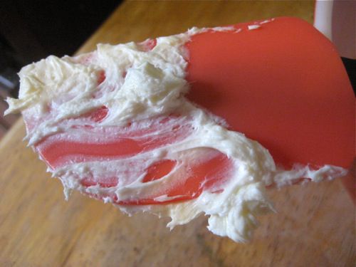 A rubber spatula smeared with cream cheese.