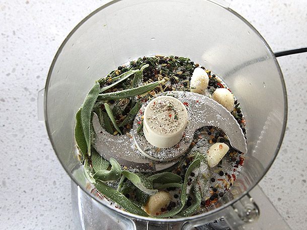 Herbs and spices for turkey porchetta (turchetta) in a food processor before being pulsed into a rub.