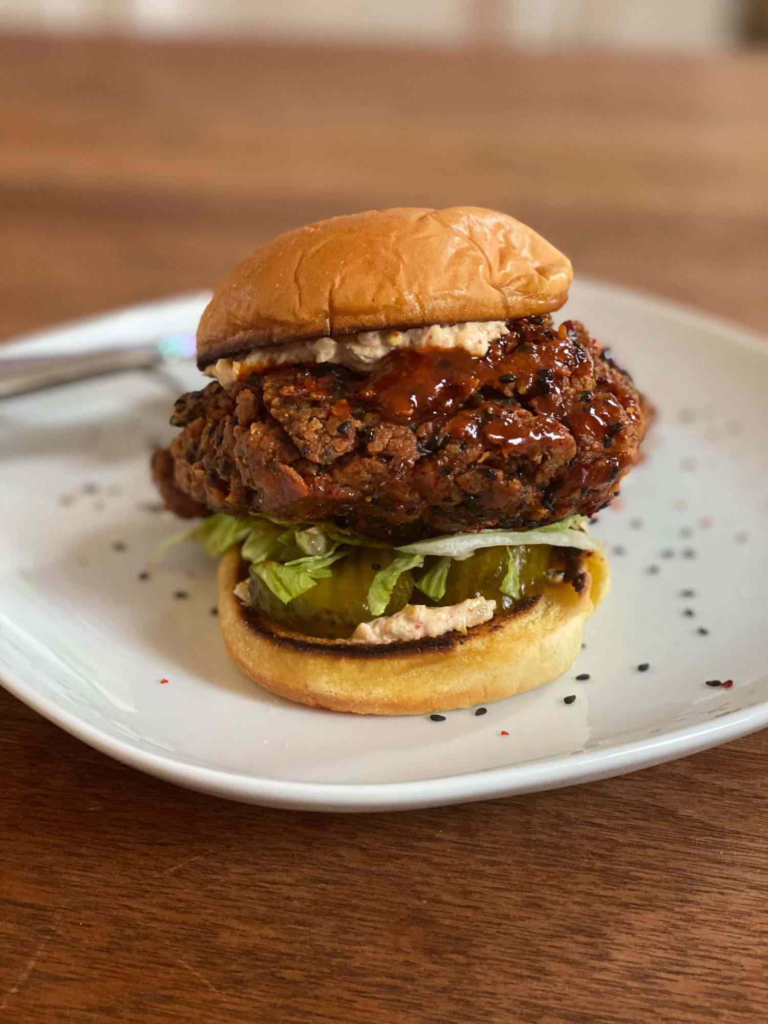 kimchi-brined fried chicken sandwich on a plate