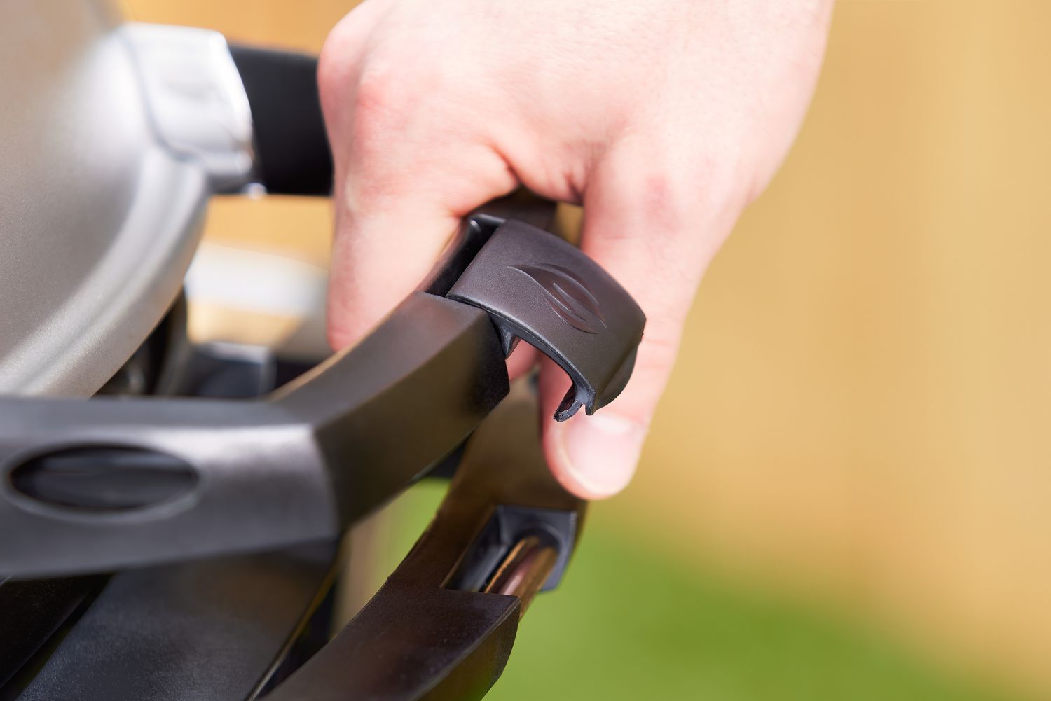 A closeup on the handle of the Napoleon Travel portable gas grill.