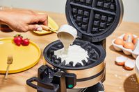 Person pouring batter into Cuisinart WAF-F4 Double Flip Belgian Waffle Maker