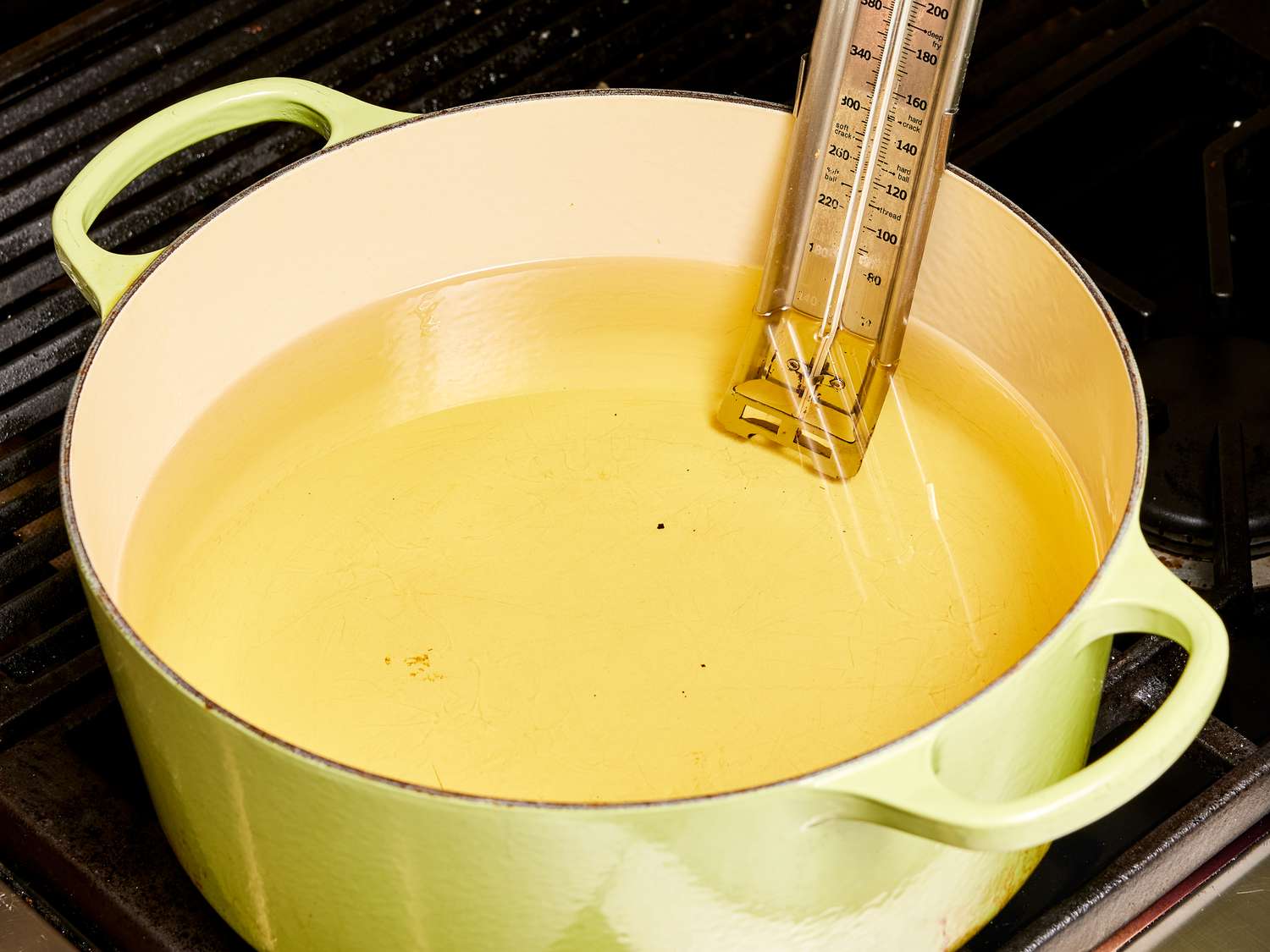 Dutch oven filled with oil and a thermometer 