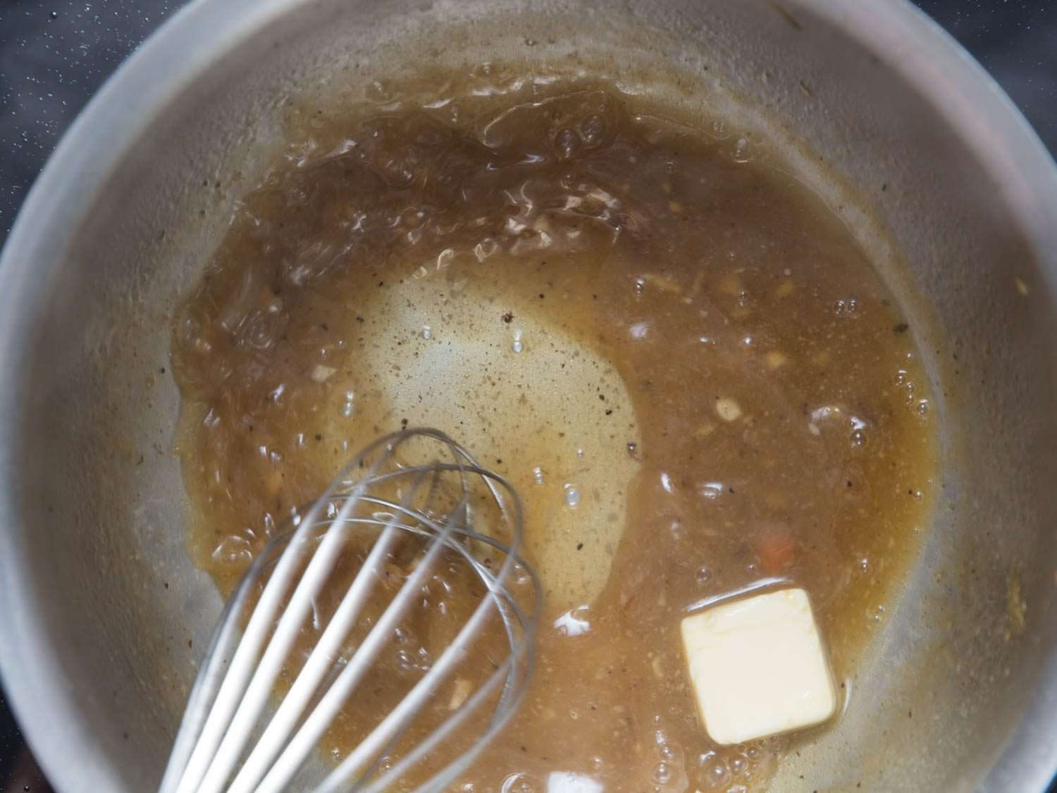 Butter is whisked into the reduced braising liquid.