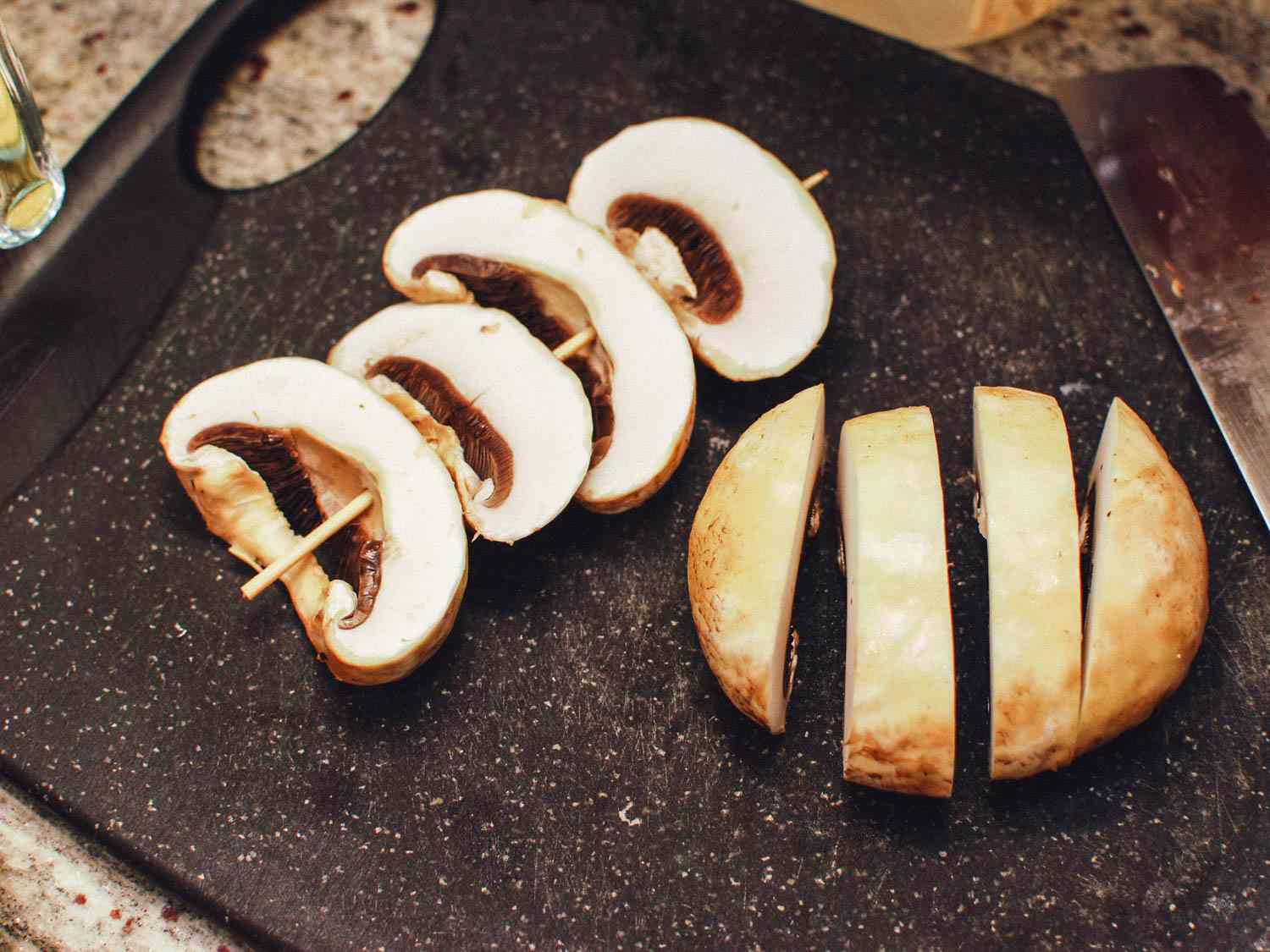 Mushrooms sliced and skewered, ready for grilling.