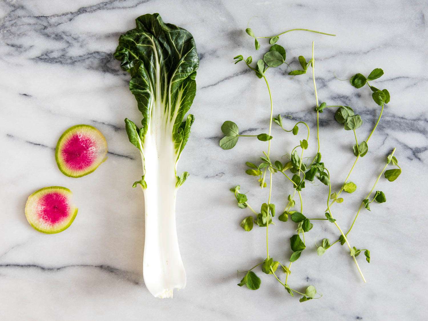 Raw vegetables on a marble surface, destined for soup.