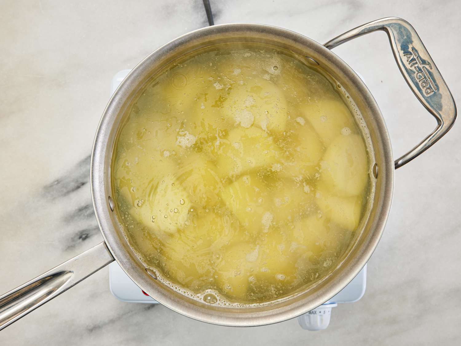 Overhead view of boiling potatoes