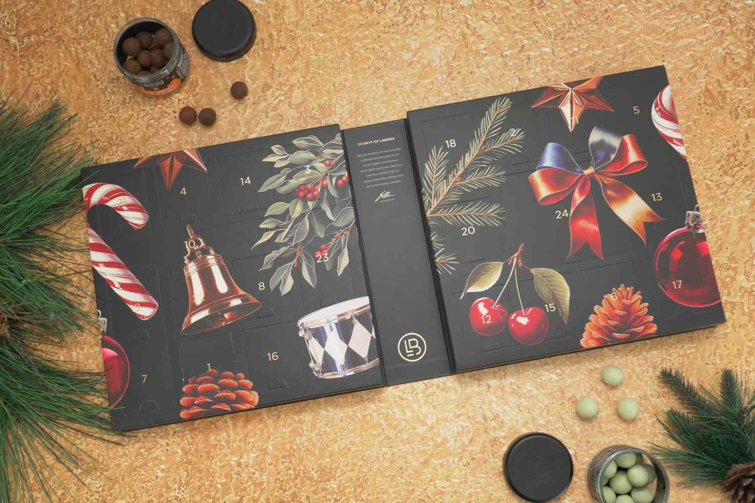 The Lakrids by Bülow Holiday Advent Calendar laid open next to some Christmas tree branches