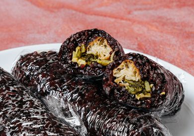 Tuan Fan rolls on a white plate and peach colored surface 