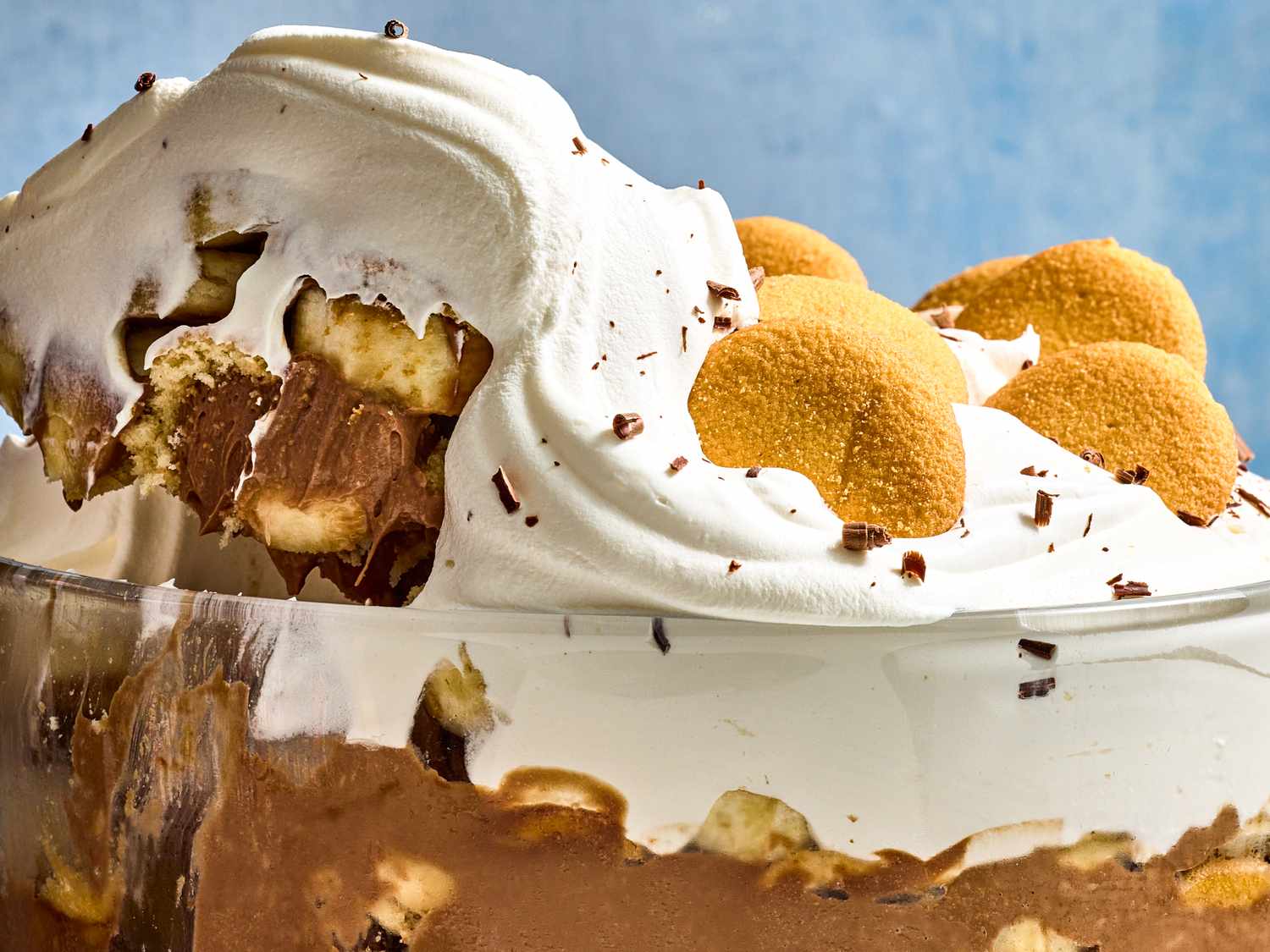 Chocolate pudding layered with bananas, whipped cream topping, and cookie pieces in a dessert dish